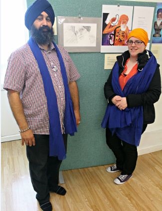 Chaz Singh (organiser of exhibition) and Melody Sale (artist)- Melody?s pencil sketch drawing of Bapu Surat Singh is in view; credit Hawk-Eye Photography